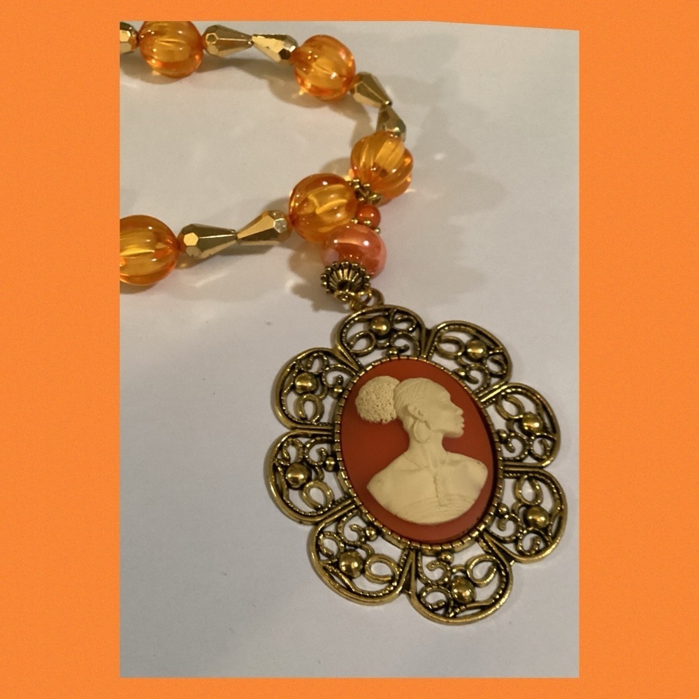 Orange lady cameo necklace.